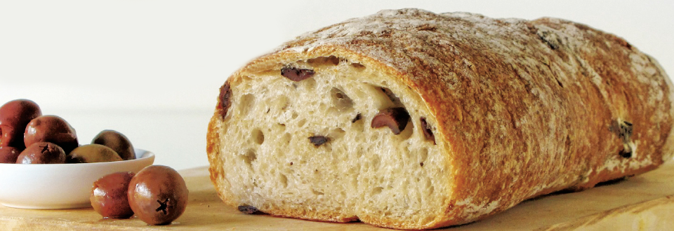 Baked olive bread with a bowl of olives